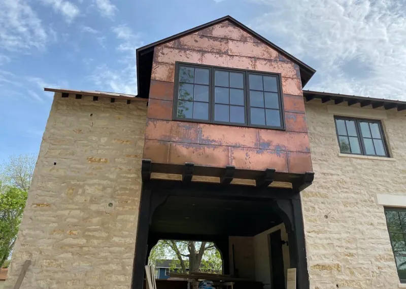 Copper metal panel facade on a stone building for Roof Repair in Larchmont