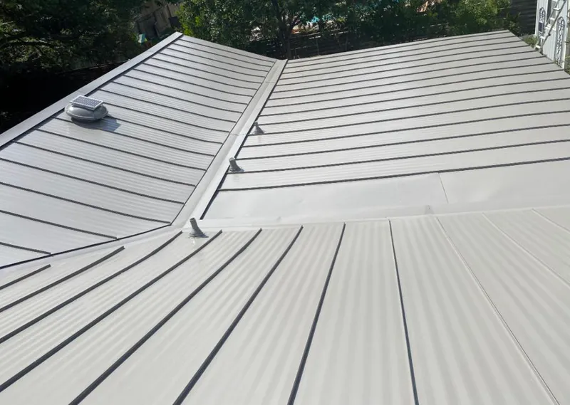 Solar attic fan installed on a metal roof for Roof Ventilation in Larchmont